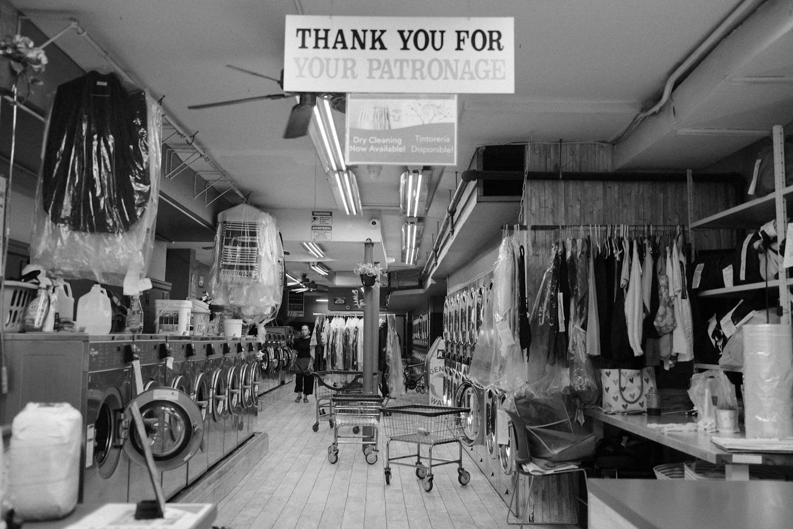 Dry-cleaning shop with garments on racks and professional equipment